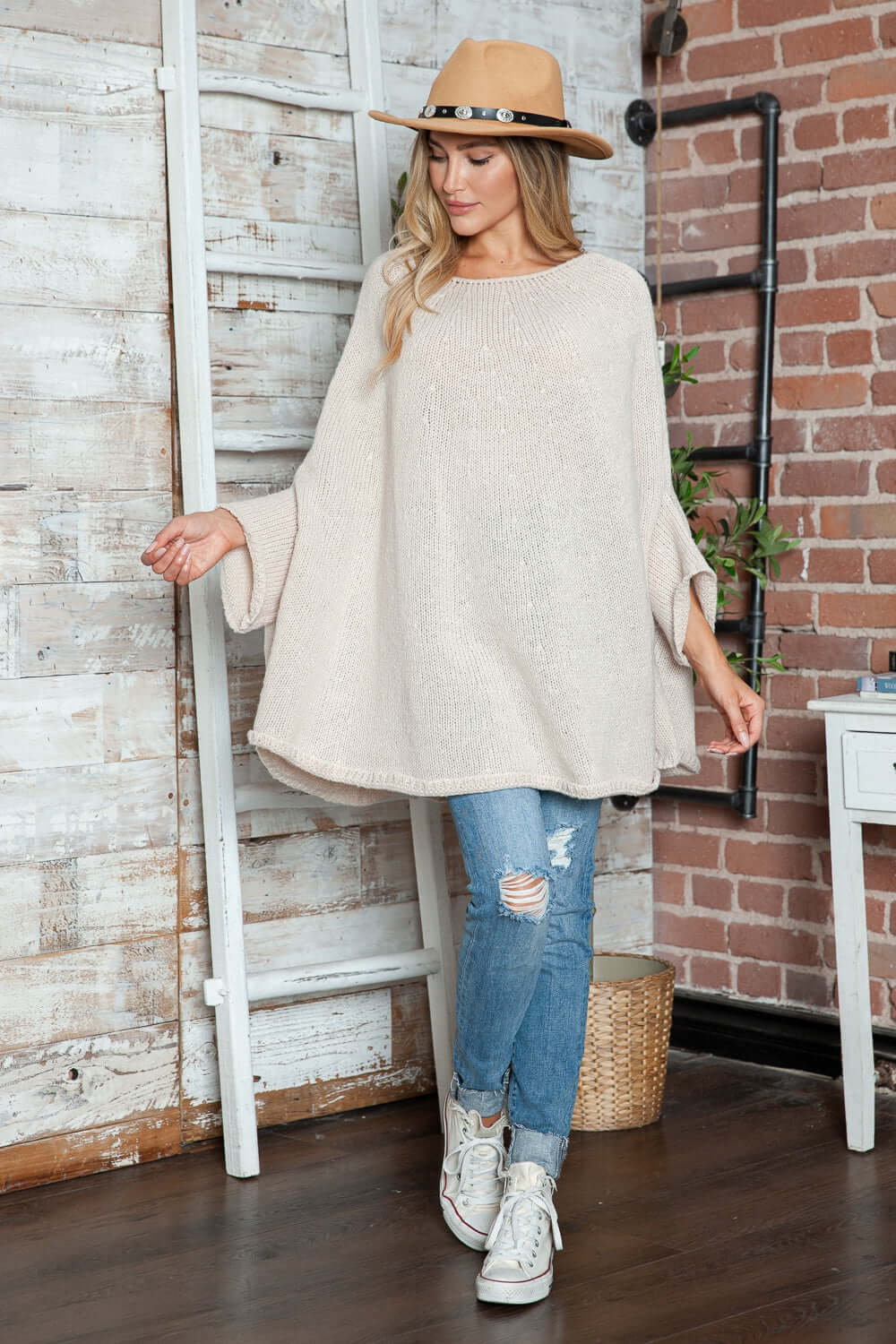 Cozy Bella Road batwing sleeve sweater with round neck, paired with ripped jeans and sneakers, perfect for casual style.