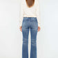 Woman wearing Cat's Whiskers High Waist Flare Jeans showcasing retro high waist and flare leg design from the back.