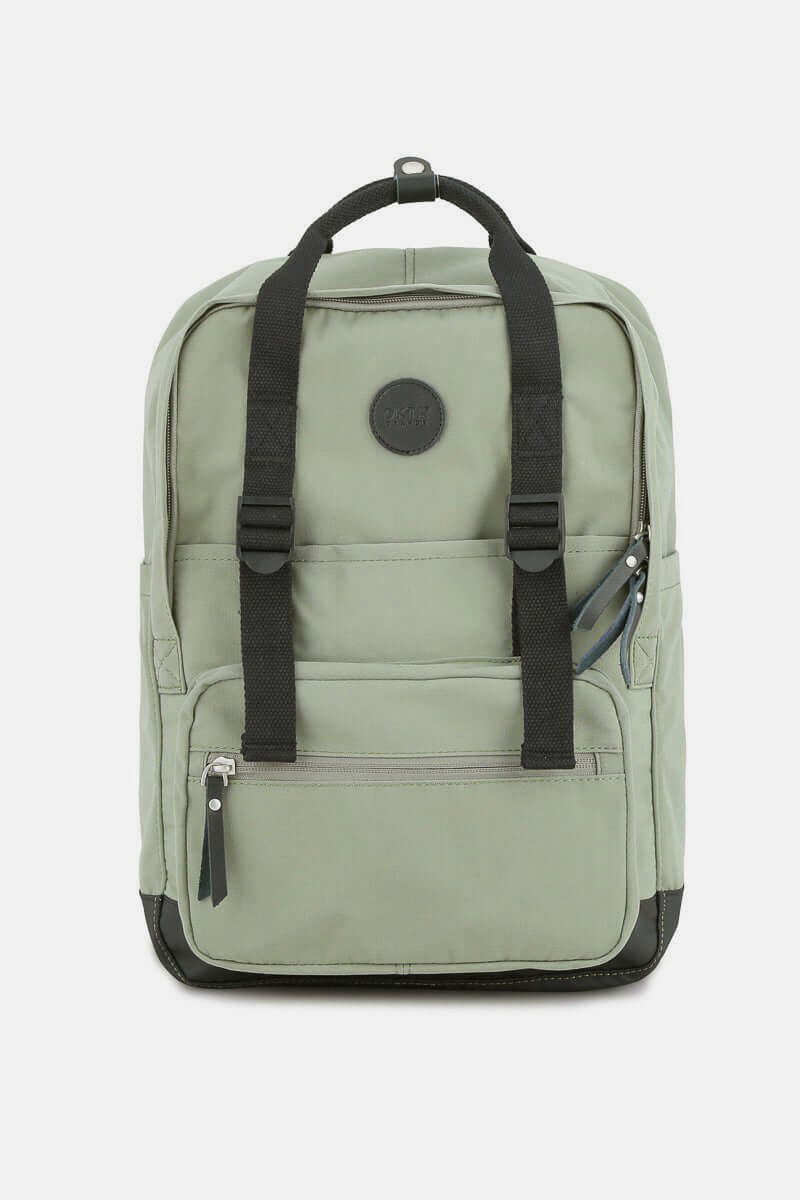 Sage green waterproof canvas backpack with side pockets and sturdy black straps, perfect for adventures and everyday use.