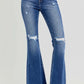 High rise distressed flare jeans with raw hem and retro vibe. Perfect for trendy looks with ankle boots or heels.