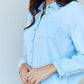 Woman wearing Blue Jean Baby Denim Button Down Shirt Top in Light Blue with long sleeves and a pointed collar.