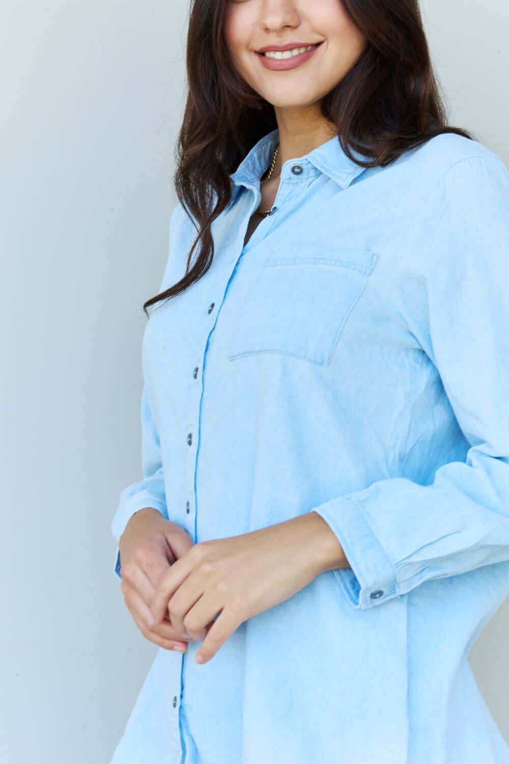 Woman wearing Blue Jean Baby Denim Button Down Shirt Top in Light Blue with long sleeves and a pointed collar.