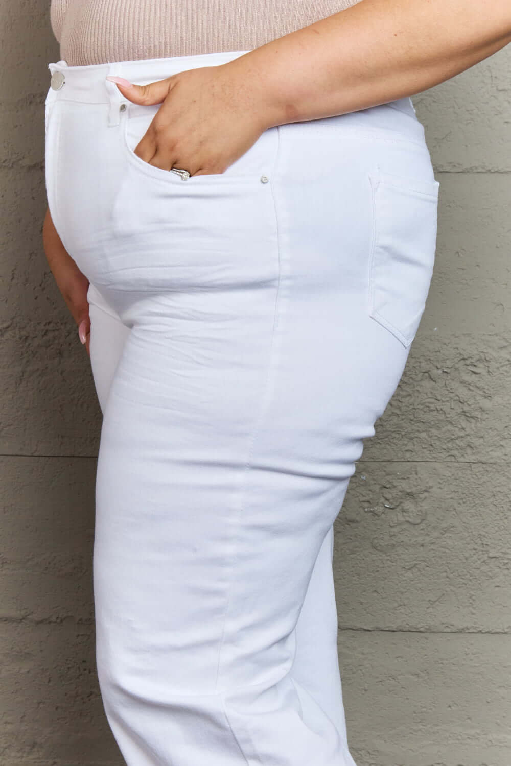 Close-up of woman wearing Raelene High Waist Wide Leg Jeans in White by Risen Jeans, showcasing flattering fit and comfortable high-rise design.