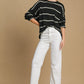 Cozy Umgee wool blend striped round neck sweater styled with white jeans and heels, perfect for casual or dressy occasions.