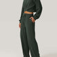 Woman wearing Bella Road Crisscross Round Neck Top and Drawstring Pants Set in dark green, showcasing comfortable and stylish casual wear.