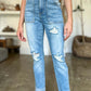 Woman wearing distressed straight Judy Blue Jeans with patch pockets