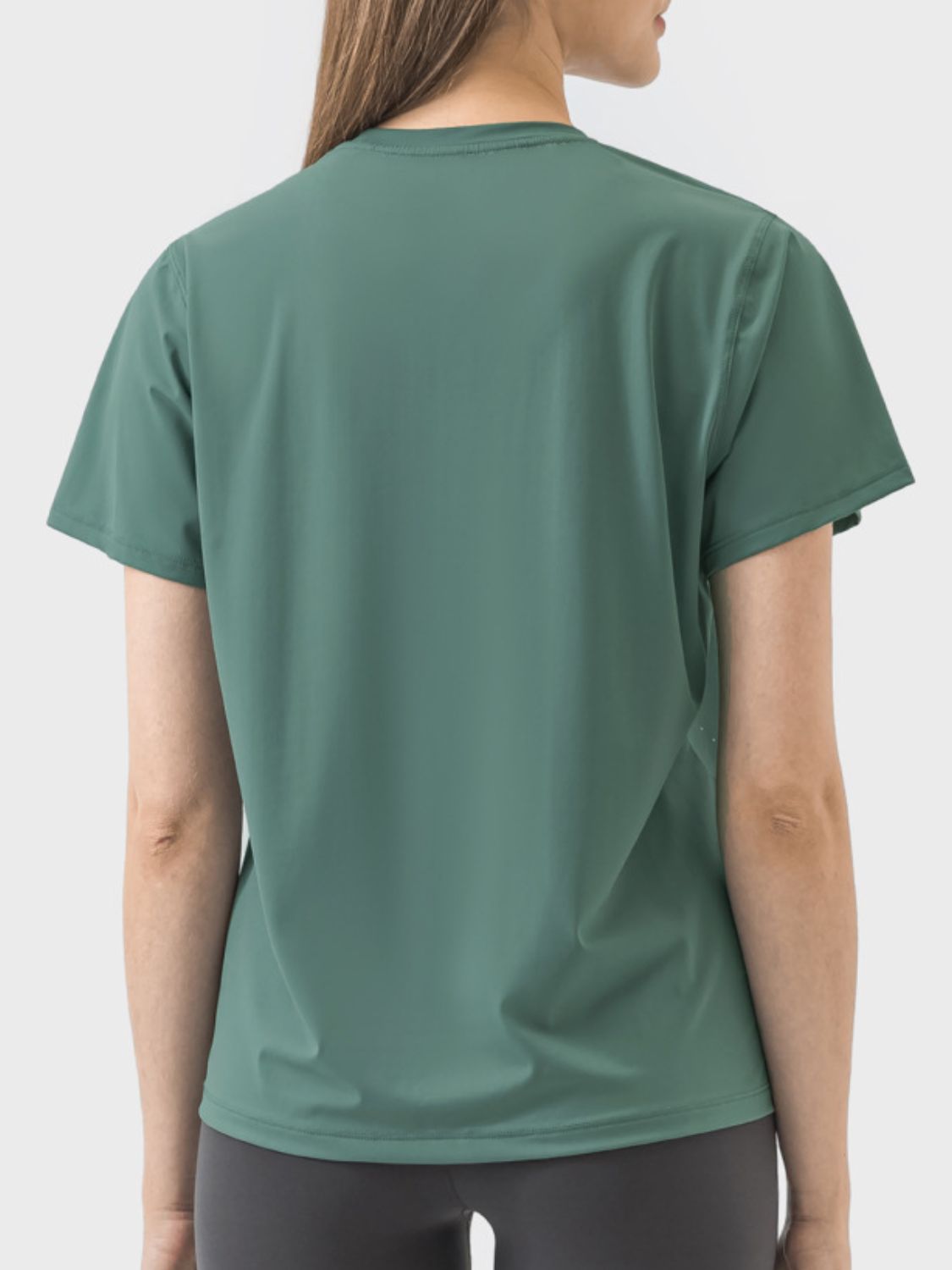 Back view of dark green Millennia Slit Round Neck Short Sleeve Active T-Shirt, showcasing its stylish design and breathable fabric.