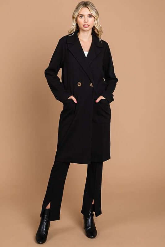 Stylish woman wearing a double-breasted black lapel collar coat, showcasing elegance and chic fashion.