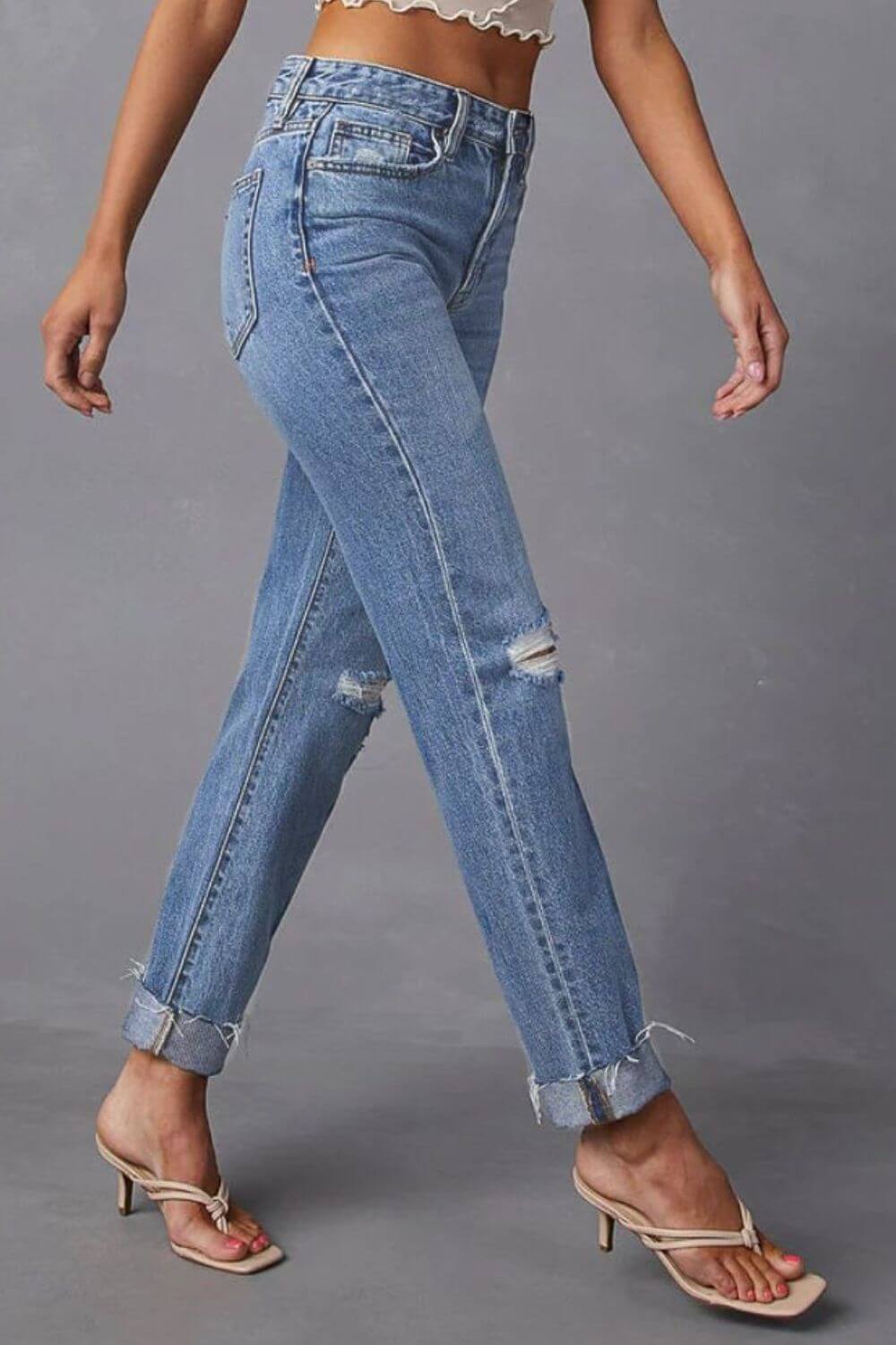 Fashion-forward model wearing Distressed Raw Hem Straight Jeans with Pockets, paired with high heels. Perfect chic casual style