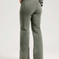 Woman wearing buttoned raw hem jeans with pockets, slightly stretchy, 97% cotton and 3% elastane, comfortable fit.