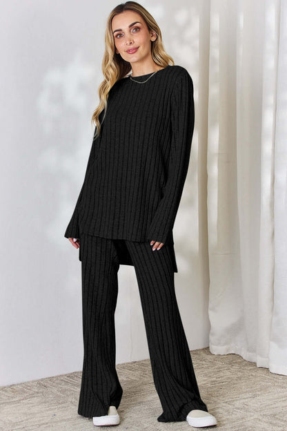 Ribbed High-Low Top and Wide Leg Pants Set in black, featuring slightly stretchy material, modeled by a woman.