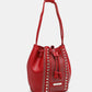 Nicole Lee USA Amy Studded Bucket Bag in red pebbled vegan leather with stud and zipper detailing, drawstring closure, and metal feet.