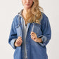 Woman wearing lightweight zip up hooded denim shirt by Risen Jeans. Casual oversized design, perfect for pairing with leggings, joggers, or denim.