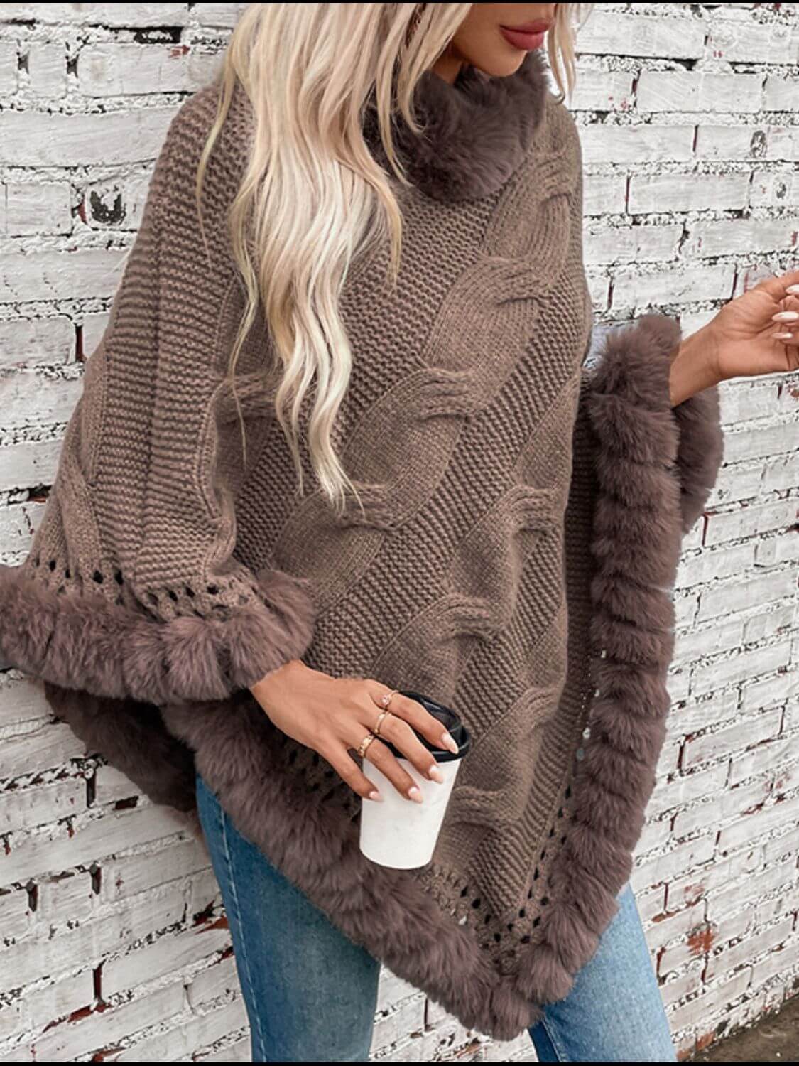 Cozy Bella Road Fuzzy Hem Cable-Knit Poncho in brown, perfect for chilly days, stylishly paired with a coffee cup.