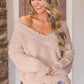 Woman wearing Bella Road frayed hem dropped shoulder sweater, showing a playful and casual fashion style.