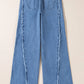 Back view of Bella Road Raw Hem Wide Leg Jeans with Pockets, showcasing the unique raw hem and wide leg design in a light blue denim.