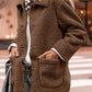 Woman wearing Bella Road Sherpa Pocketed Collared Neck Long Sleeve Jacket in brown, standing outdoors.