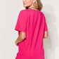 Woman wearing a pink MAMA round neck short sleeve T-shirt, viewed from the back.