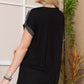 Woman wearing a Color Block Round Neck Short Sleeve T-Shirt in black, showcasing the back view in a casual setting.