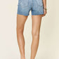 Back view of high waist rhinestone decor denim shorts modeled, showcasing flattering fit and Judy Blue Jeans quality.