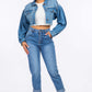 Woman wearing High Waist Pleated Waist Mom Jeans paired with a cropped denim jacket and white sneakers