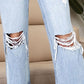 Close-up of Distressed High Waist Jeans with Pockets, featuring a stylish ripped design, perfect for a trendy casual look.