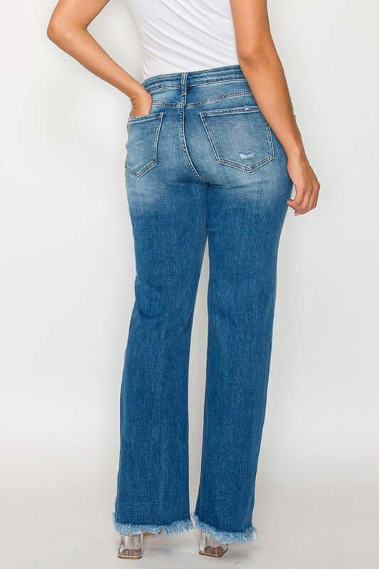 Woman showcasing the back view of bytos Raw Hem Distressed Mid Rise Straight Jeans in a trendy blue wash.