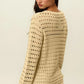 Woman wearing a Round Neck Openwork Knit Cover Up in beige, showcasing the stylish back design and texture, perfect for layering over outfits.