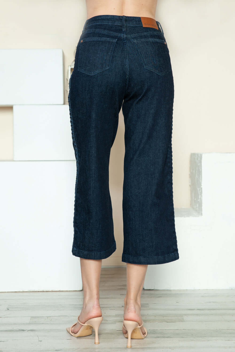 Back view of Judy Blue crop wide leg jeans with side seam braid detail, showcasing the unique design and relaxed fit.