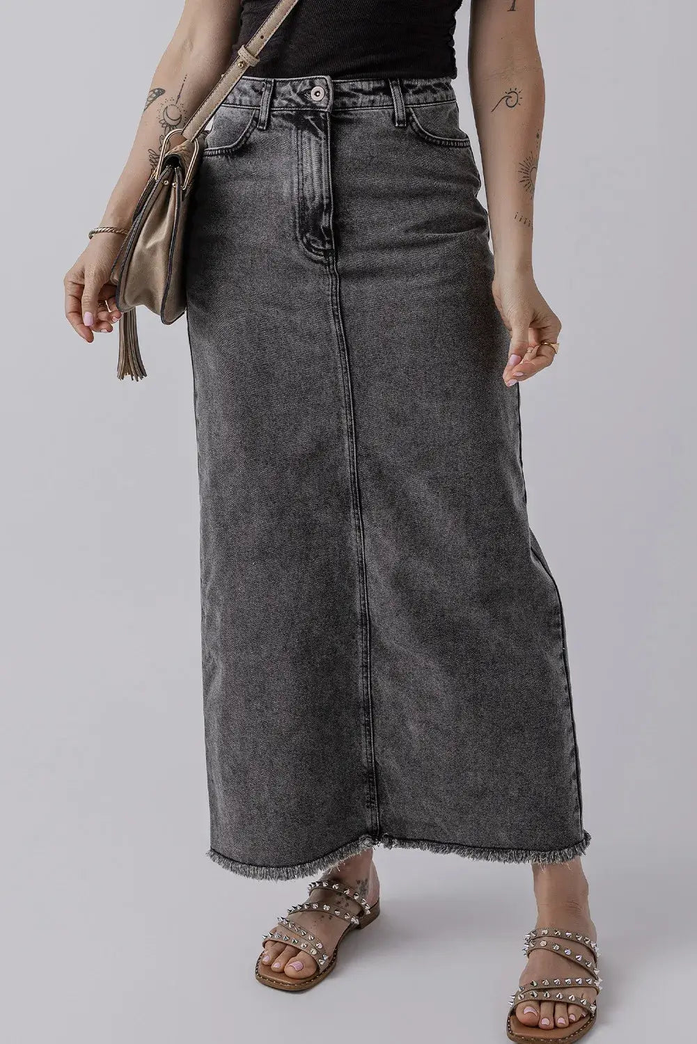 Woman wearing Bella Road Raw Hem Midi Denim Skirt with Pockets and sandals, showcasing casual edgy style.