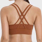 Stylish crisscross back design of Millennia Active Tank in warm brown, perfect for workouts and comfortable movement.