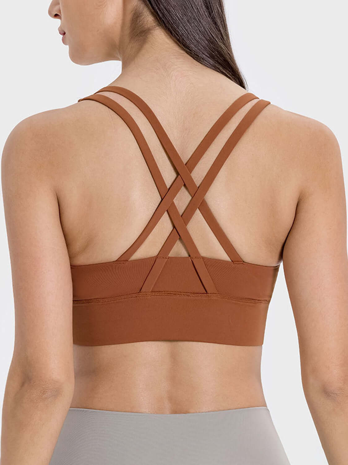 Stylish crisscross back design of Millennia Active Tank in warm brown, perfect for workouts and comfortable movement.