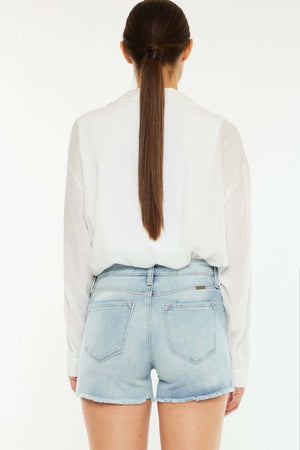 High Rise Side Slit Denim Shorts featuring a high-waist and back view on a model, paired with a white shirt.