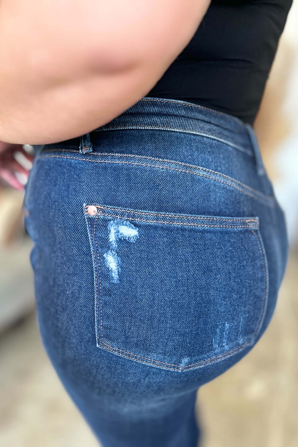 Close-up of High Waist Rigid Magic Heavy Destroy Straight Jeans showcasing the back pocket and heavy distressing detail, Judy Blue Jeans.