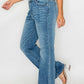 Woman showcasing bytos Cat's Whiskers Mid Rise Bootcut Jeans with a stylish casual look and light wash denim.