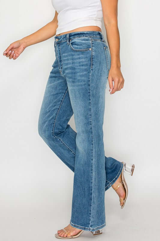 Woman showcasing bytos Cat's Whiskers Mid Rise Bootcut Jeans with a stylish casual look and light wash denim.