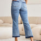 Woman wearing Judy Blue release hem cropped bootcut jeans with heels, showcasing modern bootcut silhouette and stylish cropped length.