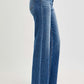 Side view of RISEN Tummy Control High Rise Raw Cut Jeans showcasing stylish high-waisted design and raw hem.