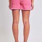 Back view of a person wearing pink drawstring raw hem shorts from YMI Jeans, showcasing trendy casual style and comfortable design.