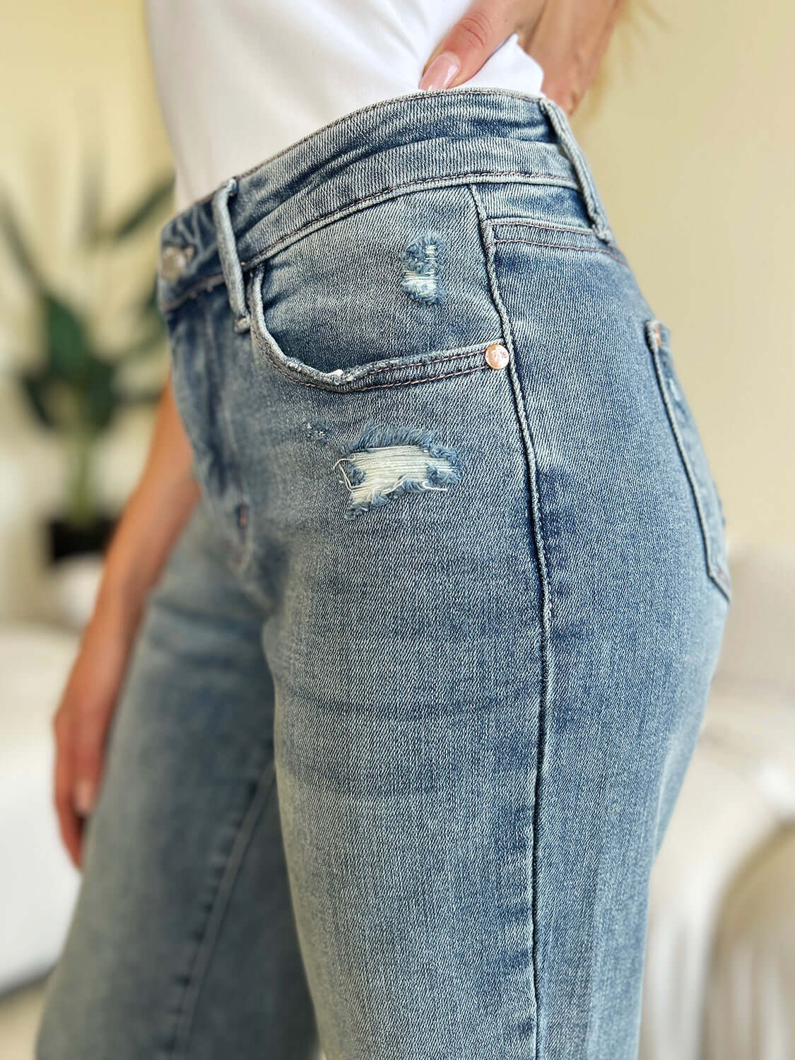 Close-up of High Waist Distressed Straight Jeans by Judy Blue, featuring a flattering fit with edgy distressed detailing.