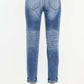 Back view of High Rise Distressed Mom Jeans showing flattering high waist and distressed detailing in premium denim material