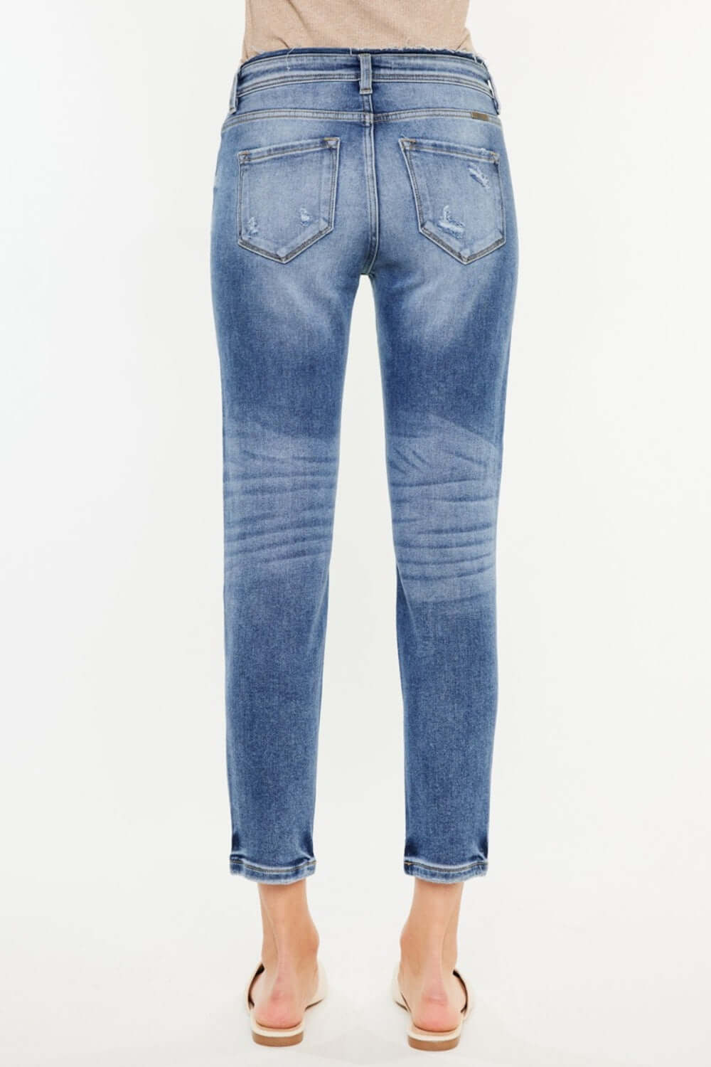 Back view of High Rise Distressed Mom Jeans showing flattering high waist and distressed detailing in premium denim material