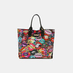 Colorful reversible Nicole Lee USA handbag with vibrant lips print design and black handles. Versatile and stylish accessory.