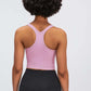 Back view of Millennia Racerback Sports Bra in soft pink, showcasing a sleek, sporty design perfect for yoga and workouts.