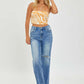 Woman wearing High Rise Frayed Hem Wide Leg Risen Jeans paired with a stylish orange top, showcasing a chic, fashion-forward look.