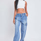 Trendy woman wearing YMI Jeans high-rise straight leg cargo jeans with comfy stretch denim and front seams, paired with a white crop top.