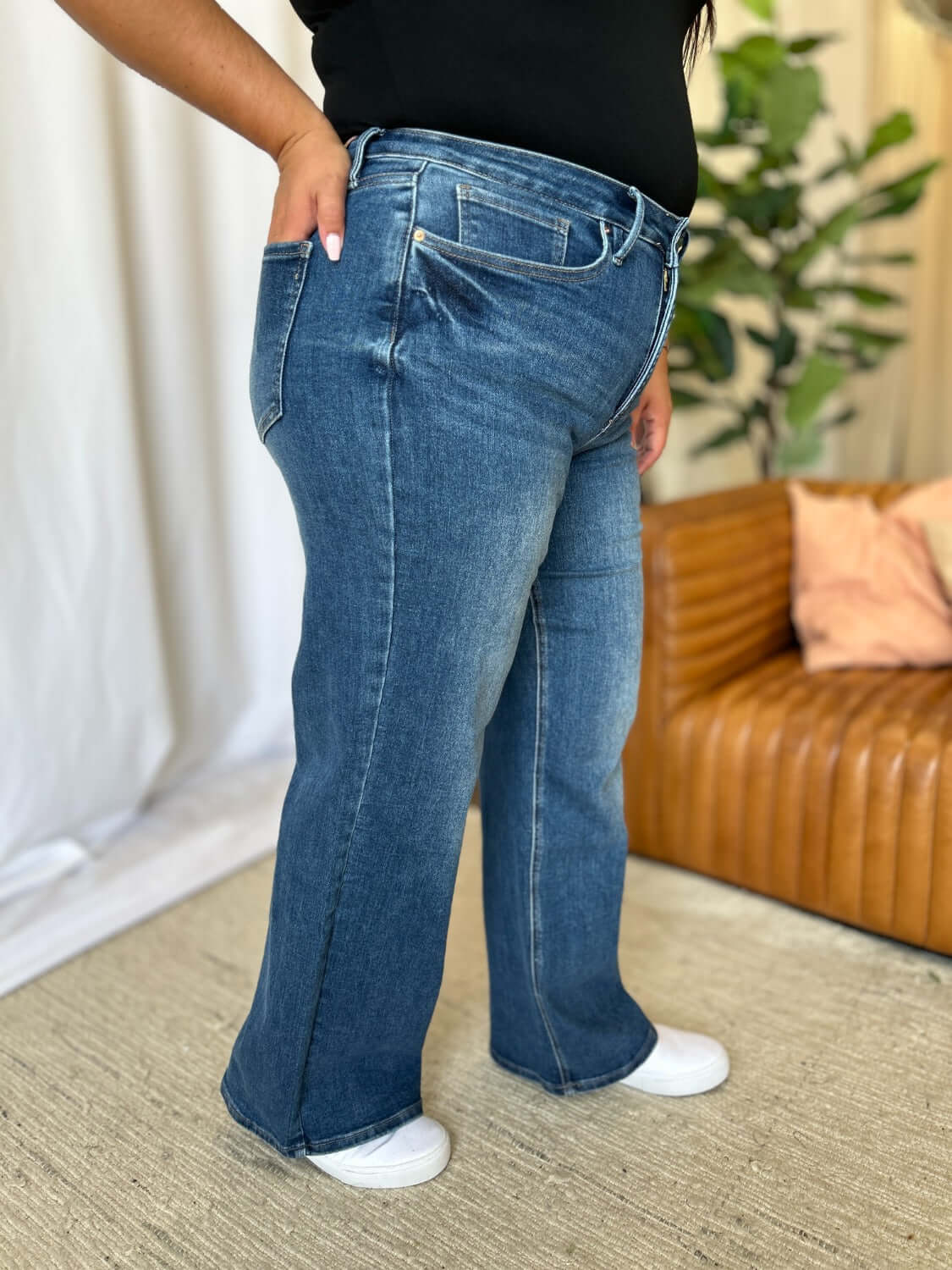 Woman wearing high rise tummy control wide leg jeans with a relaxed fit and comfortable silhouette