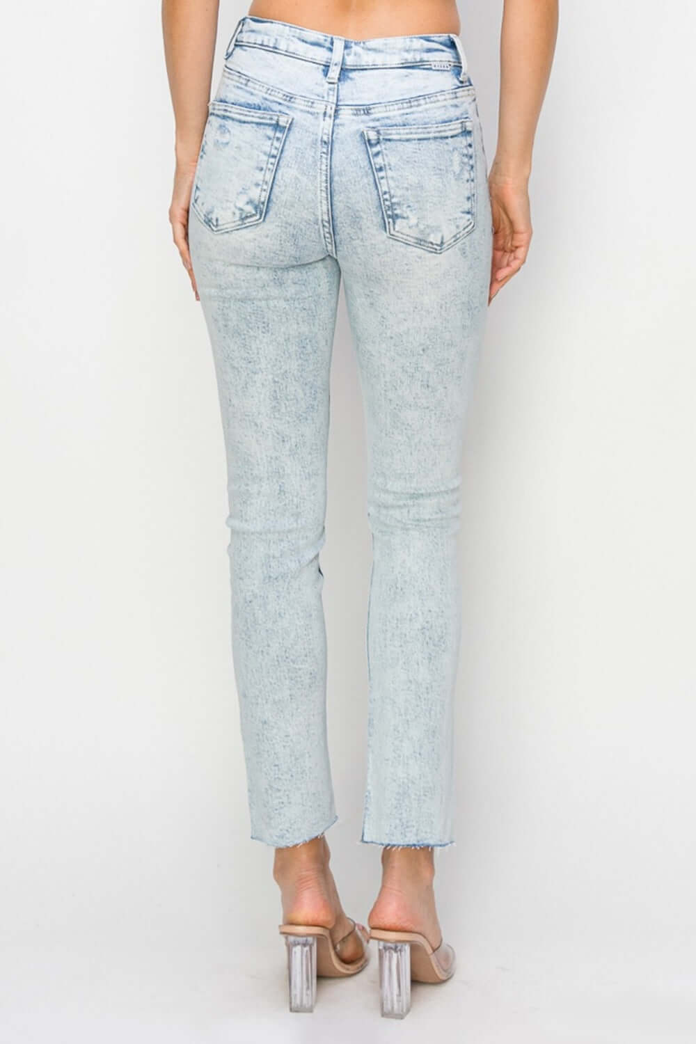 High rise distressed skinny jeans by Risen Jeans with figure-flattering silhouette and cool distressed details shown from the back.