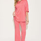 Woman wearing a pink Bamboo Drop Shoulder T-Shirt and Flare Pants Set, featuring a basic style and stretchy bamboo fiber material.