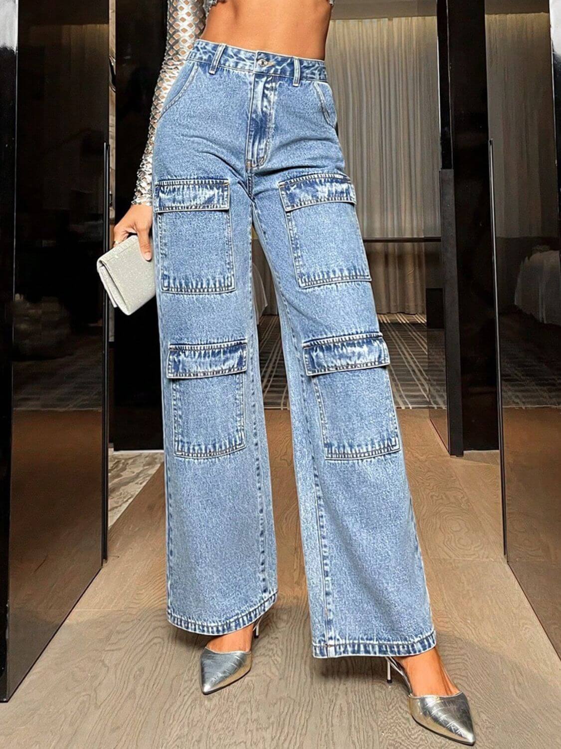 Woman wearing Bella Road Wide Leg High Waist Jeans with Pockets, paired with silver heels and holding a clutch.